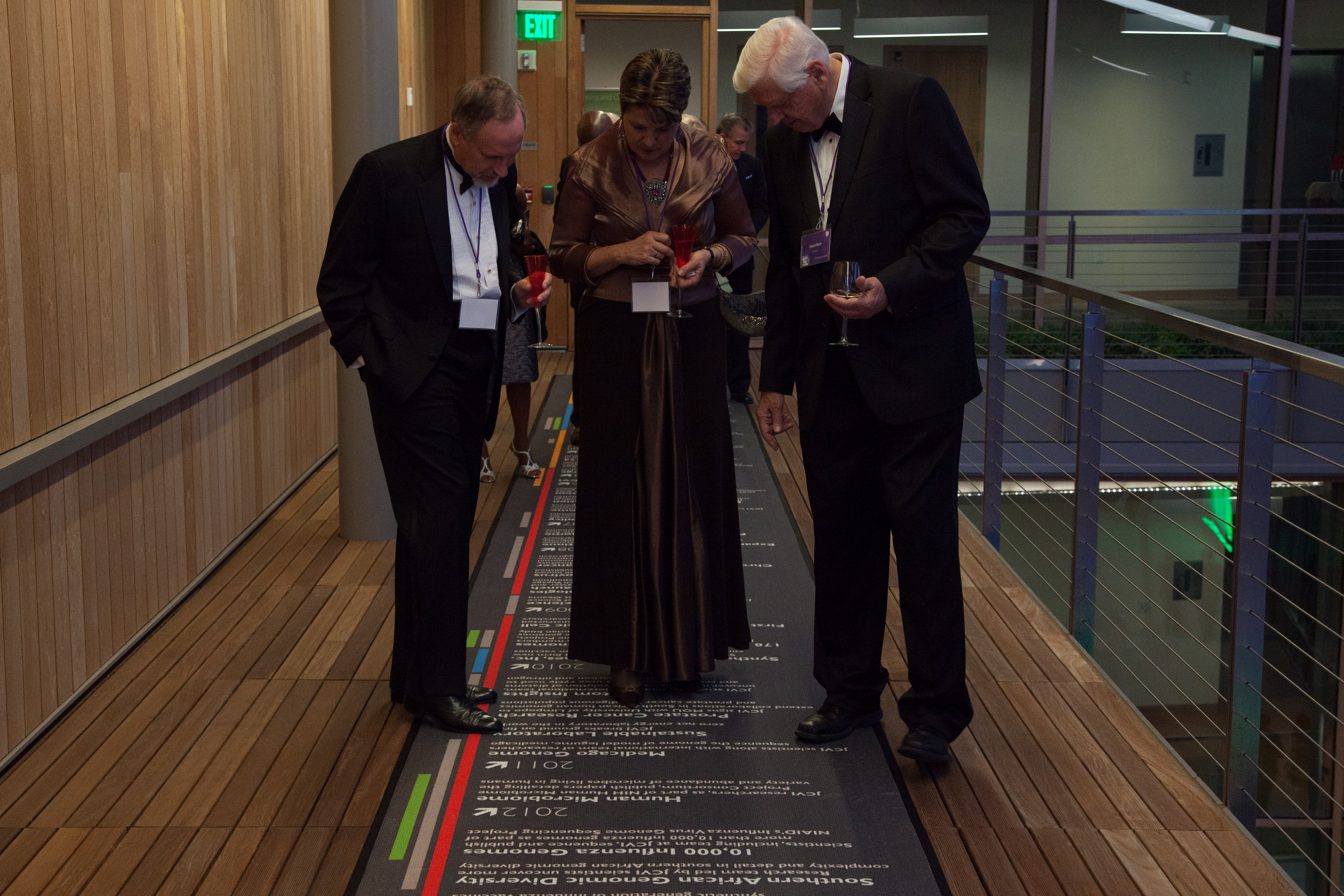 Nobel Laureate Hamilton Smith (right) walks gala attendees through JCVI advances.