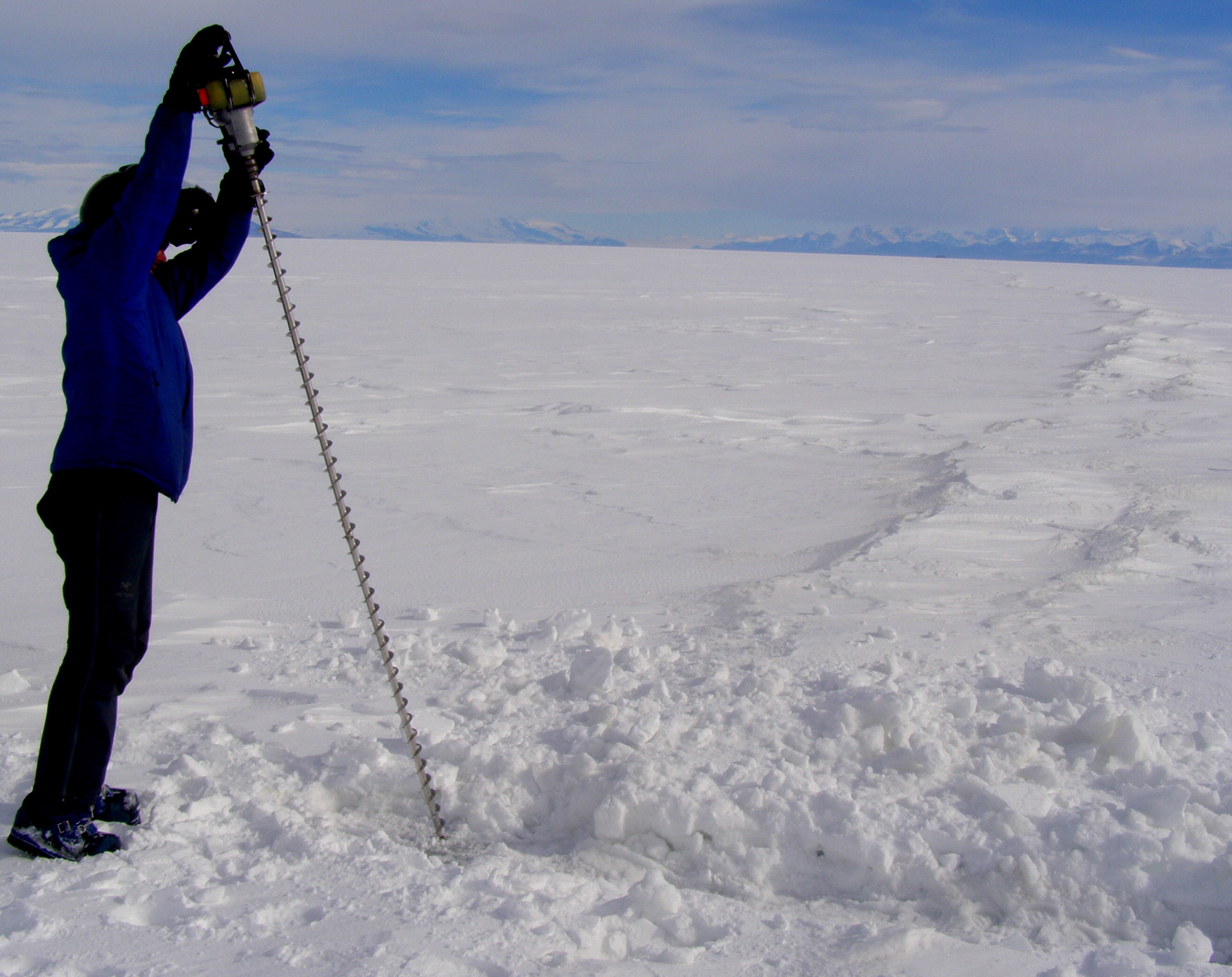 Matt drills to test the ice thickness across a crack