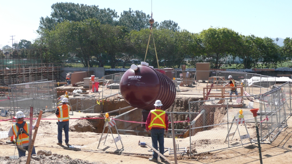 5500 gallon rainwater storage tank is lowered into place