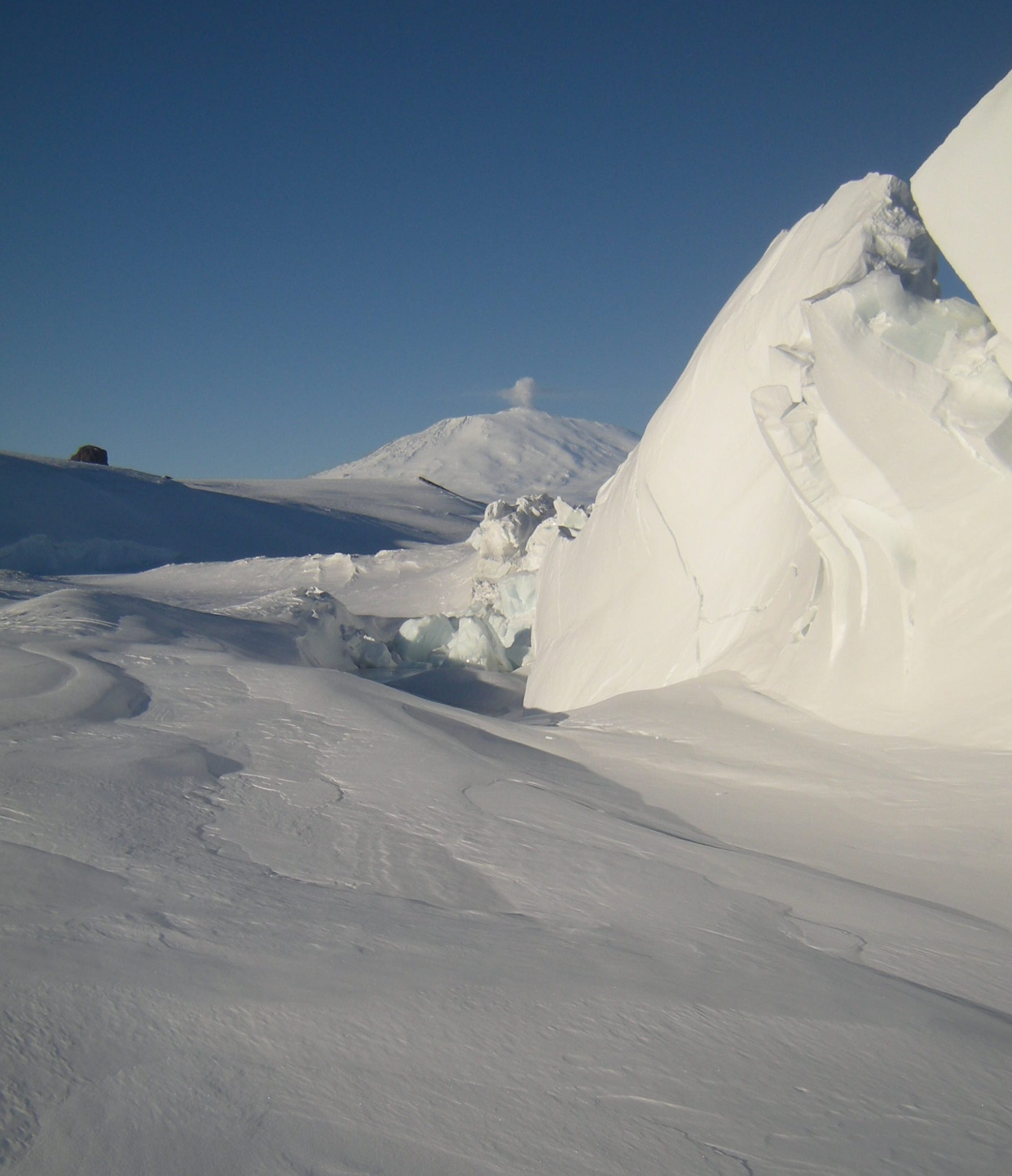 Pressure ridge on the sea ice, Erebus Volcano (with plume of steam) in the background