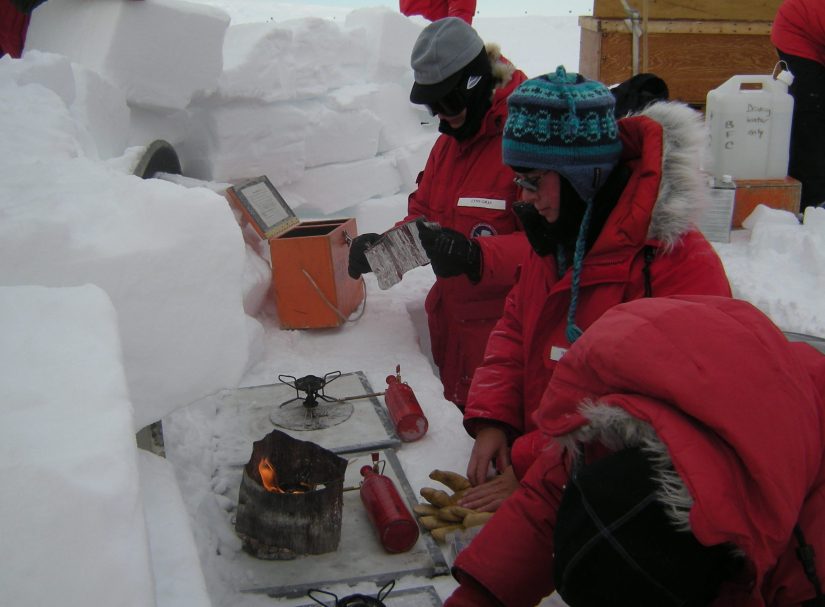 Michelle fires up a stove in the snow galley